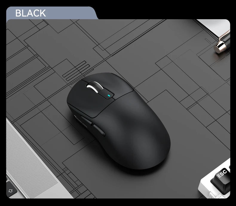 Black computer mouse on a gray surface with a grid pattern