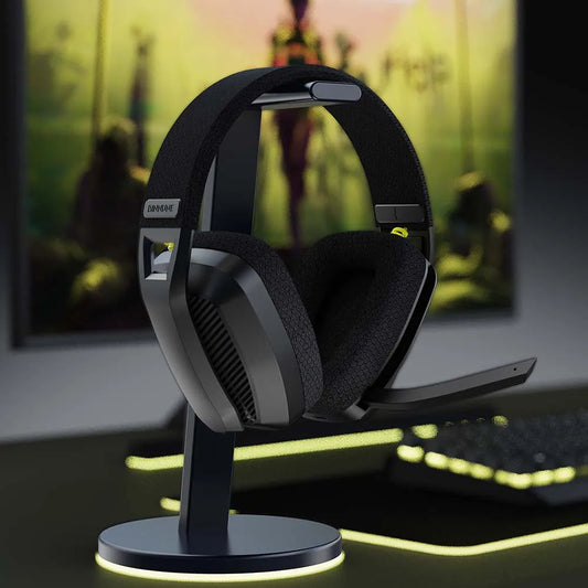 Gaming headset on a stand with a blurred gaming setup in the background